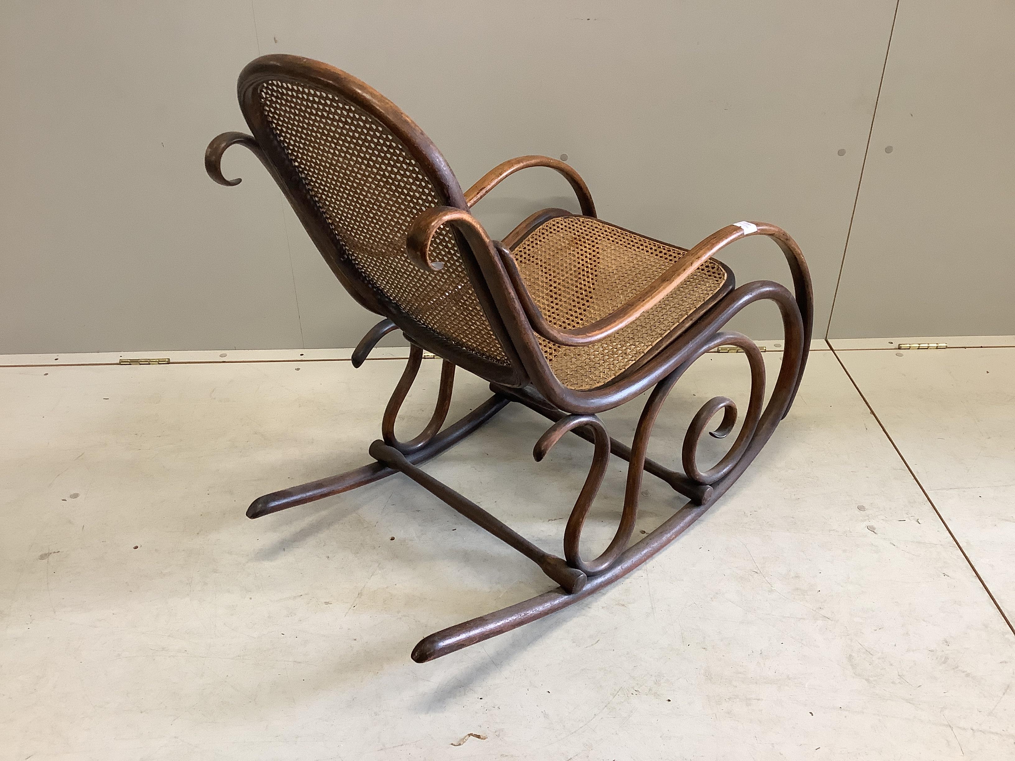 An early 20th century caned Thonet bentwood rocking chair, width 49cm, depth 90cm, height 87cm